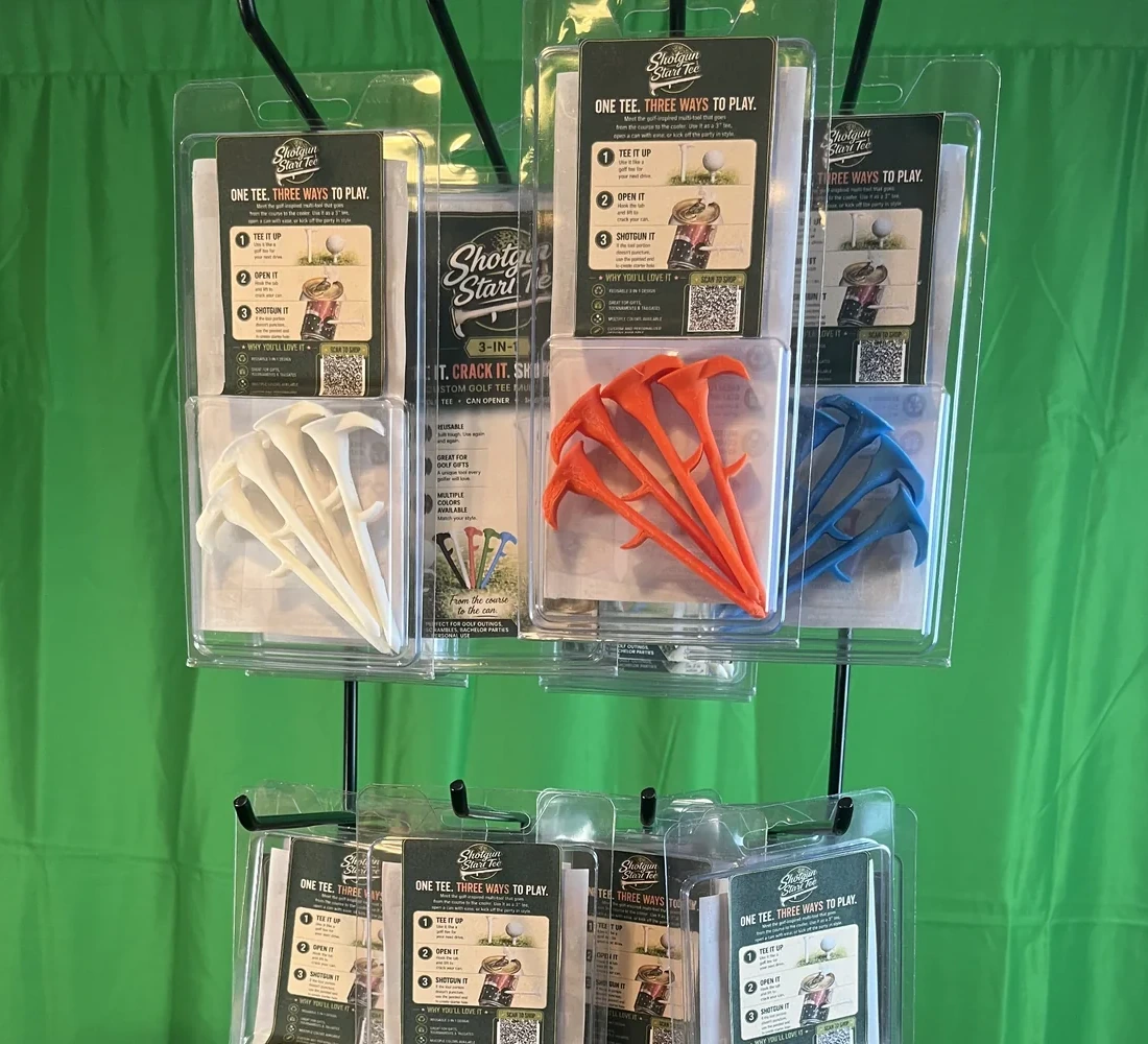 Real Shotgun Start Tee retail packages hanging in multiple colors