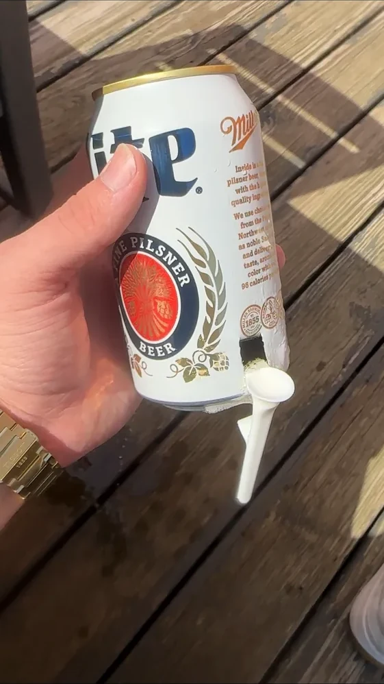 Actual Shotgun Start Tee positioned against the side of a beverage can